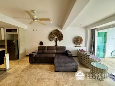 Spacious living room with modern decor and large sofa in open layout apartment.