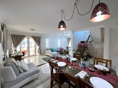Spacious open-plan living and dining area with elegant decor and natural light.