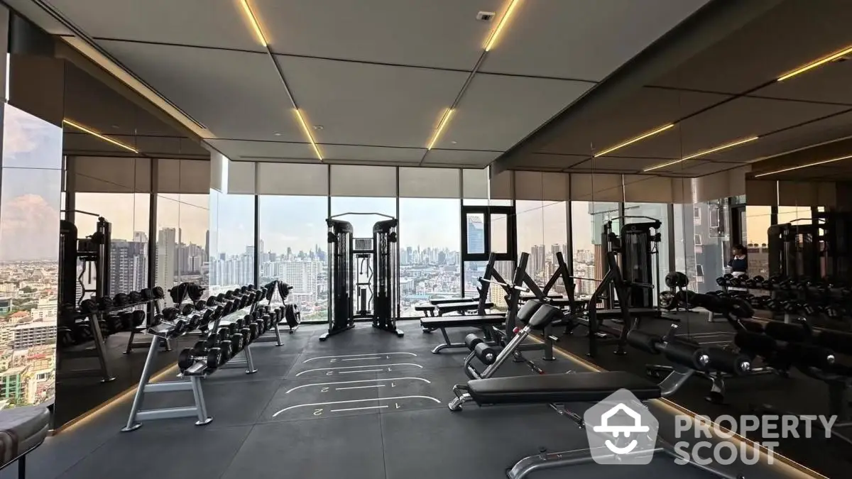 Luxurious high-rise gym with panoramic city views and modern fitness equipment.