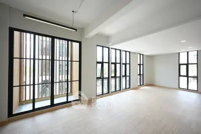 Spacious modern living room with large windows and natural light