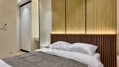 Modern bedroom with stylish wooden paneling and cozy bedding
