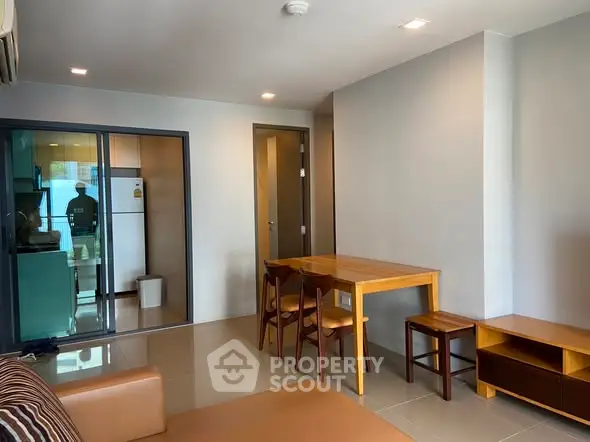 Modern living room with dining area and view into kitchen