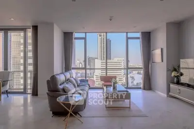Luxurious modern living room with stunning city view and elegant furnishings.
