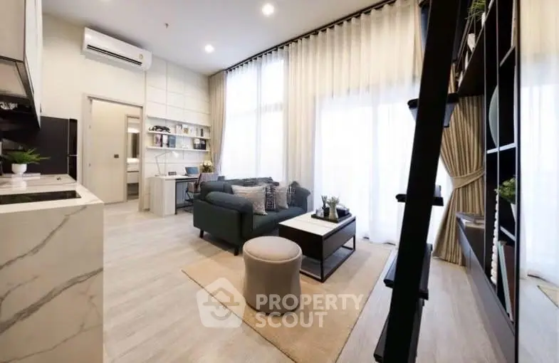 Modern living room with high ceilings, stylish furniture, and large windows for natural light.