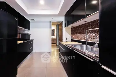 Modern kitchen with sleek black cabinets and stylish backsplash
