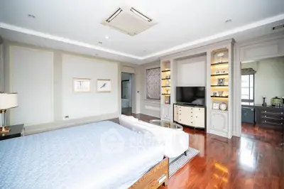 Spacious and elegant bedroom with luxurious decor and hardwood flooring