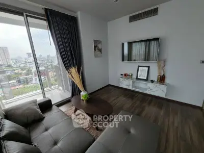 Modern living room with city view, sleek furniture, and elegant decor in a high-rise apartment.