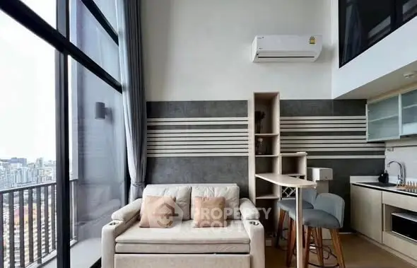 Modern loft apartment with open kitchen and city view balcony.