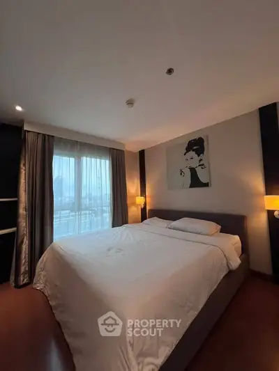 Cozy bedroom with large bed and stylish decor, featuring a window with city view.