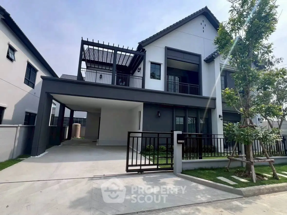 Modern two-story house with sleek design and spacious driveway in a serene neighborhood.