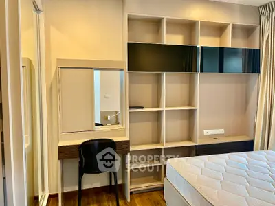 Modern bedroom with built-in shelving and stylish desk area
