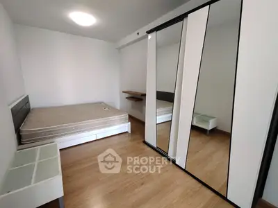 Modern bedroom with sleek mirrored wardrobe and minimalist design