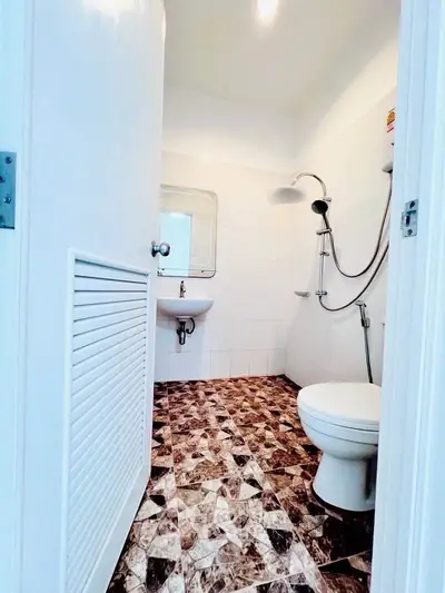 Compact bathroom with modern fixtures and unique patterned flooring
