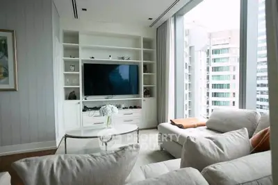 Luxurious living room with modern entertainment center and panoramic city views.