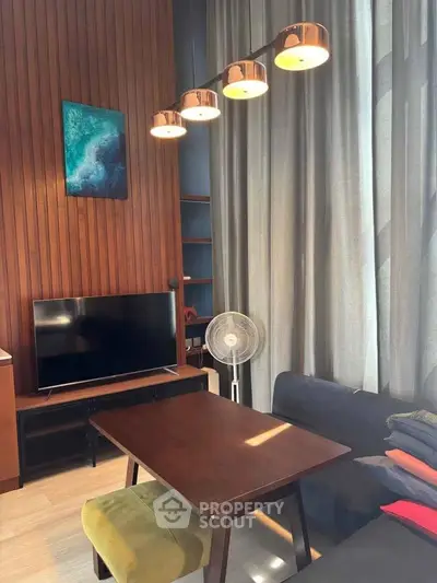 Modern living room with stylish lighting and wooden accent wall