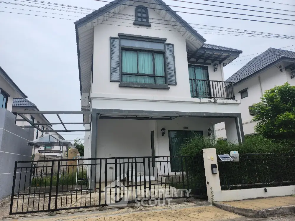 Charming two-story family home with a secure gated entrance and cozy balcony, nestled in a tranquil neighborhood offering a perfect blend of comfort and privacy.