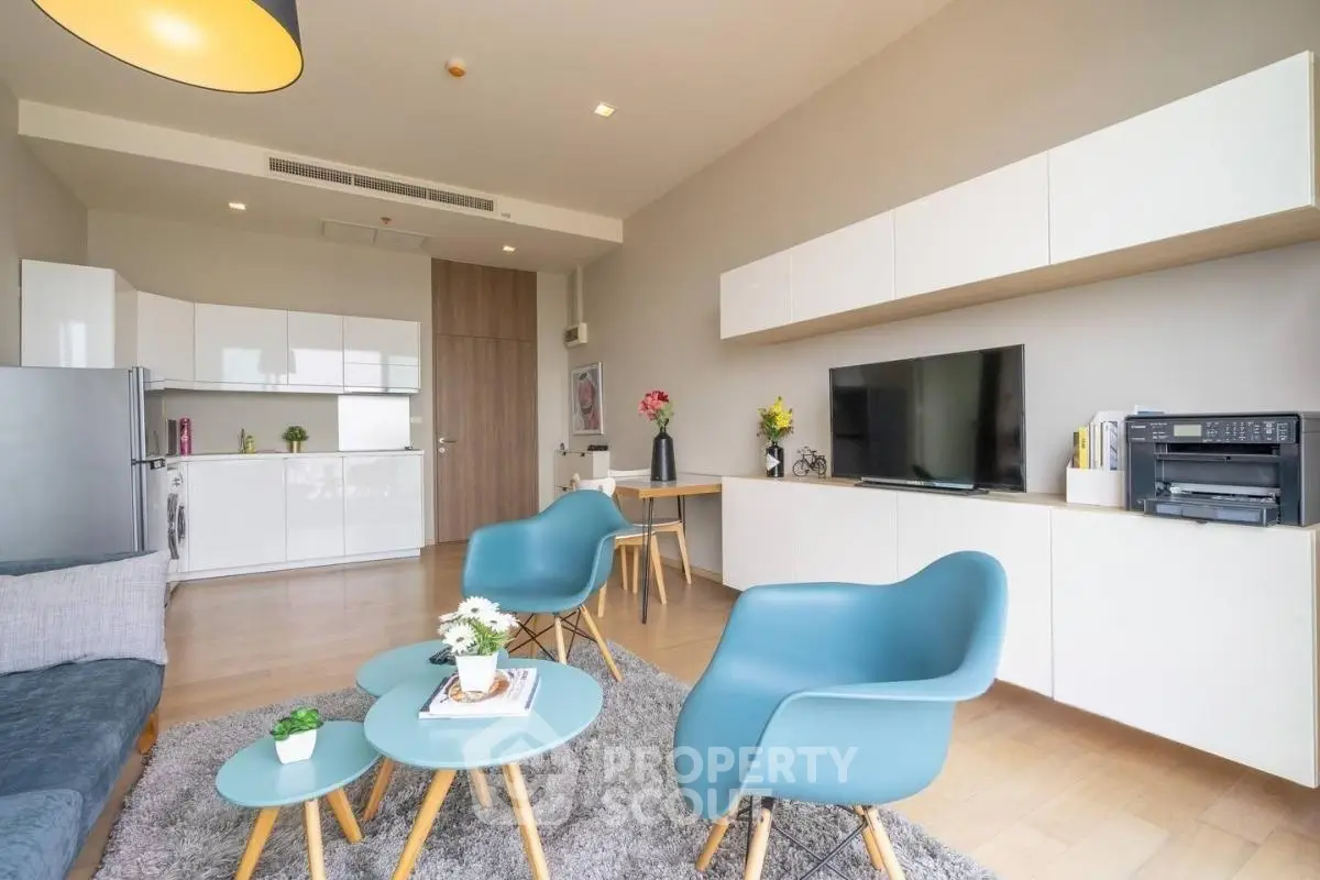 Modern living room with stylish furniture and open kitchen layout