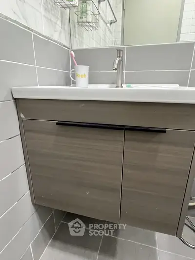 Modern bathroom with sleek vanity and stylish tile design, perfect for contemporary living.