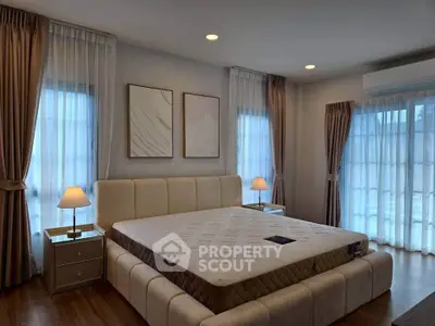Luxurious bedroom with elegant decor and ample natural light