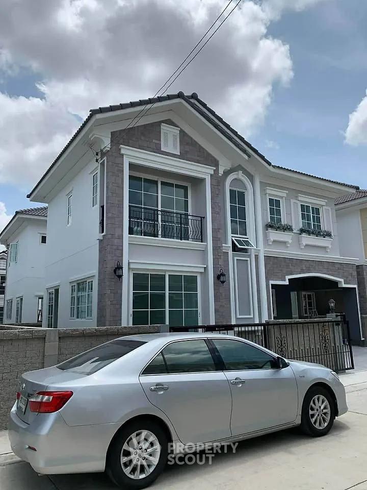 Stunning two-story house with elegant facade and spacious driveway, perfect for modern family living.