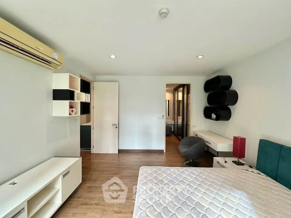 Spacious modern bedroom with stylish furniture and ample natural light