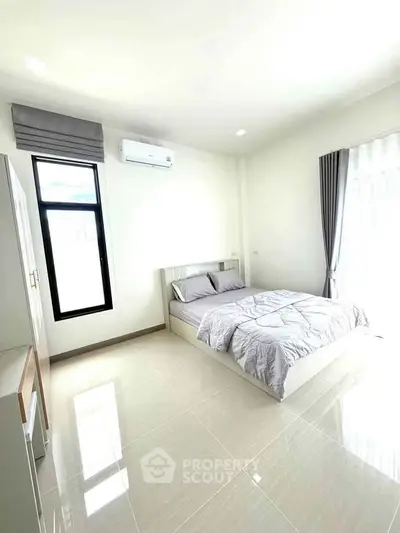Bright and airy bedroom with modern furnishings and large window