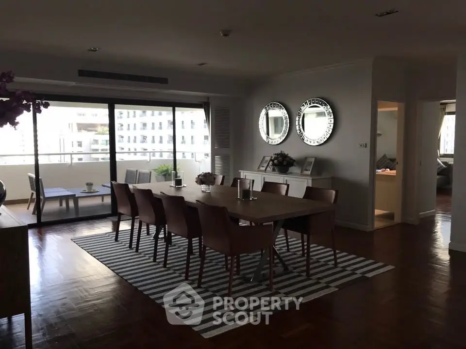 Spacious dining area with elegant decor and balcony view in modern apartment
