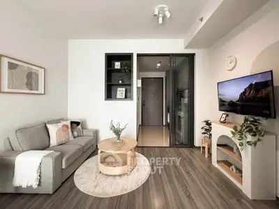 Modern living room with cozy sofa, stylish decor, and wall-mounted TV in a contemporary apartment.