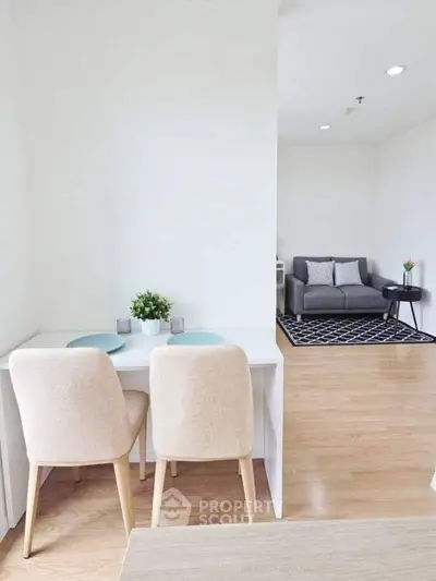 Modern open-plan living room with dining area, featuring stylish furniture and elegant decor.