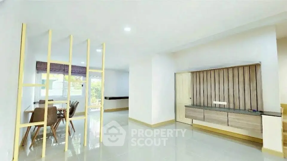Spacious modern living area with dining space and stylish partition