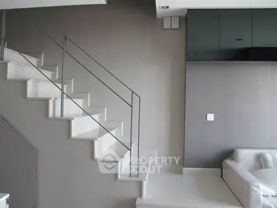 Modern interior with sleek staircase and minimalist design, perfect for contemporary living spaces.