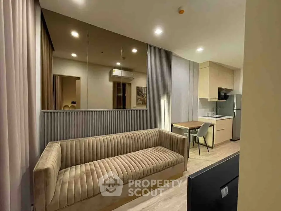 Modern living room with stylish sofa and open kitchen in a chic apartment