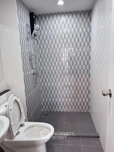 Modern bathroom with geometric tile design and shower area
