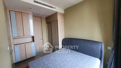 Modern bedroom with stylish wooden wardrobe and cozy bed in a contemporary apartment.