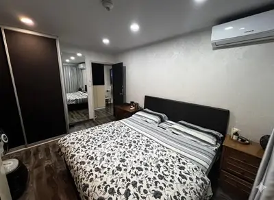 Modern bedroom with stylish decor and air conditioning unit