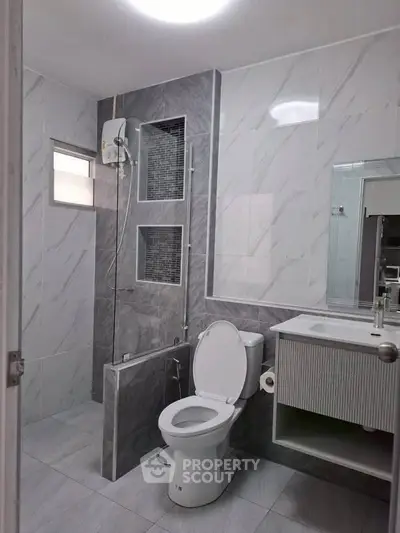 Modern bathroom with sleek gray tiles and contemporary fixtures
