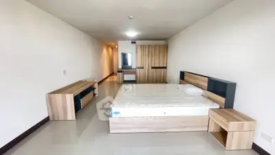 Spacious modern bedroom with sleek wooden furniture and minimalist design