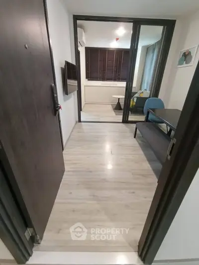 Modern apartment entrance leading to cozy living area with stylish decor.