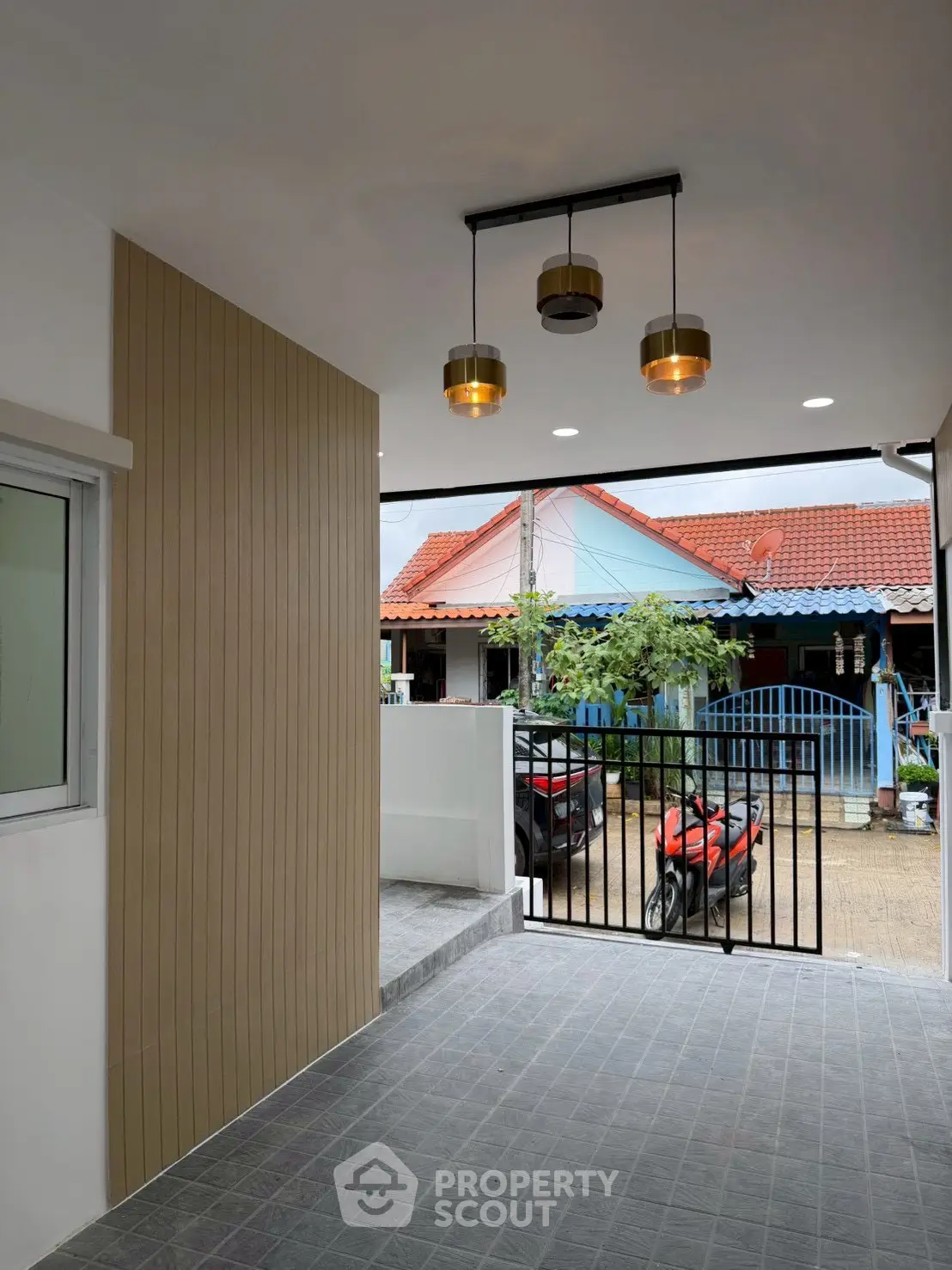 Charming residential entrance with modern lighting and secure gate, perfect for urban living.