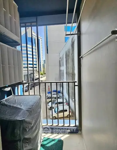 Compact balcony with city view and laundry area in modern apartment