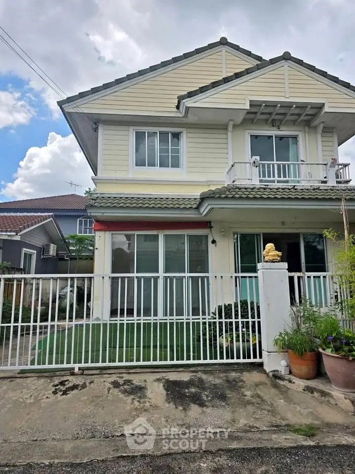 Charming two-story house with fenced yard and balcony, perfect for family living.