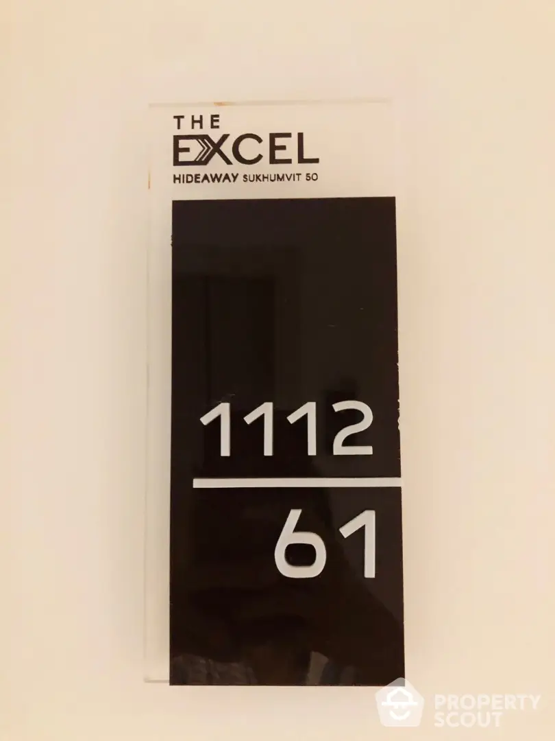 The Excel Hideaway Sukhumvit 50 property sign with unit numbers 1112 and 61.