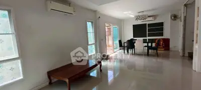 Spacious living room with dining area and large windows for natural light