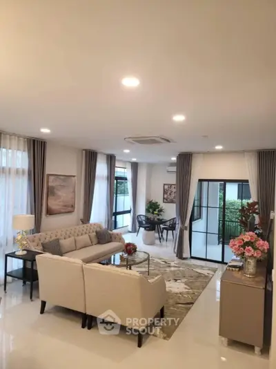 Luxurious modern living room with elegant decor and large windows offering natural light