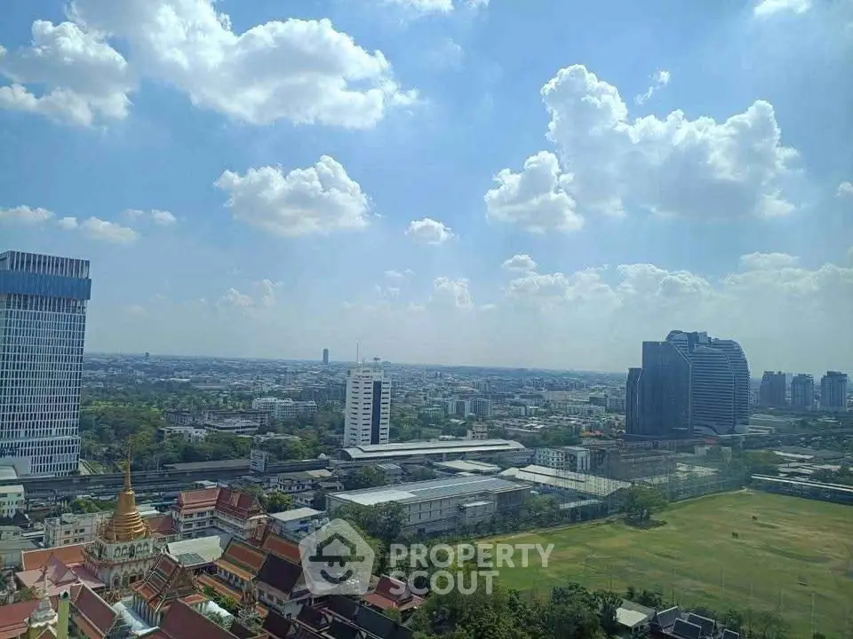 Stunning cityscape view from high-rise building showcasing expansive skyline and lush greenery.