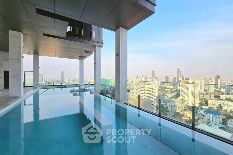 Luxurious rooftop pool with stunning city skyline view in modern high-rise building.