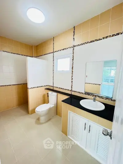Spacious modern bathroom with elegant tile design and sleek fixtures.