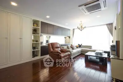 Spacious living room with elegant wooden flooring and modern furniture