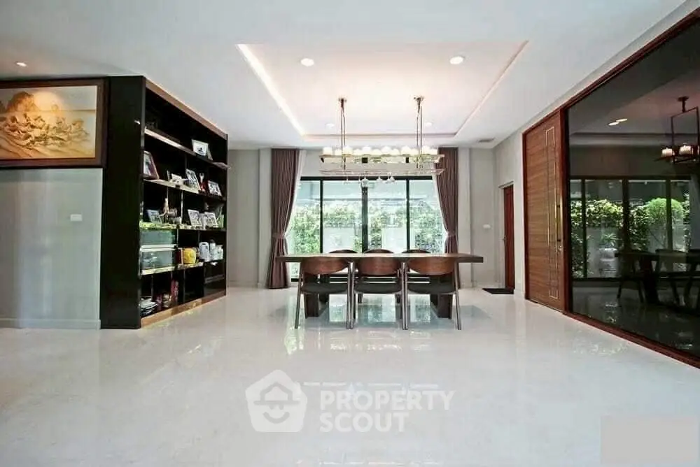 Spacious modern dining area with elegant lighting and large windows.