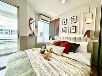 Stylish bedroom with modern decor and balcony access in a luxury apartment.